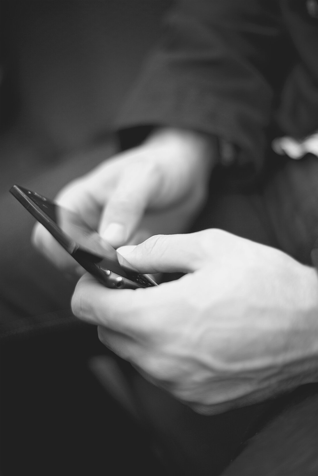 Hands holding mobile phone